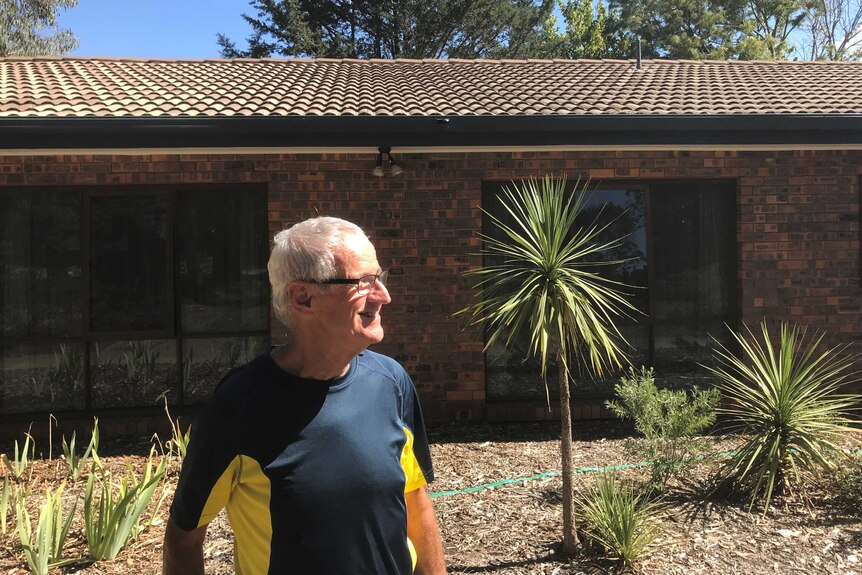 Mick Saunders in front of his house.