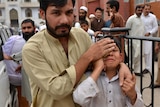 An injured Pakistani boy reacts as he arrives at a hospital.
