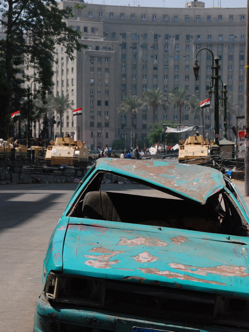 A burnt-out car in Tahrir Square