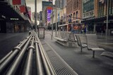 A bench in an empty Bourke Street Mall.