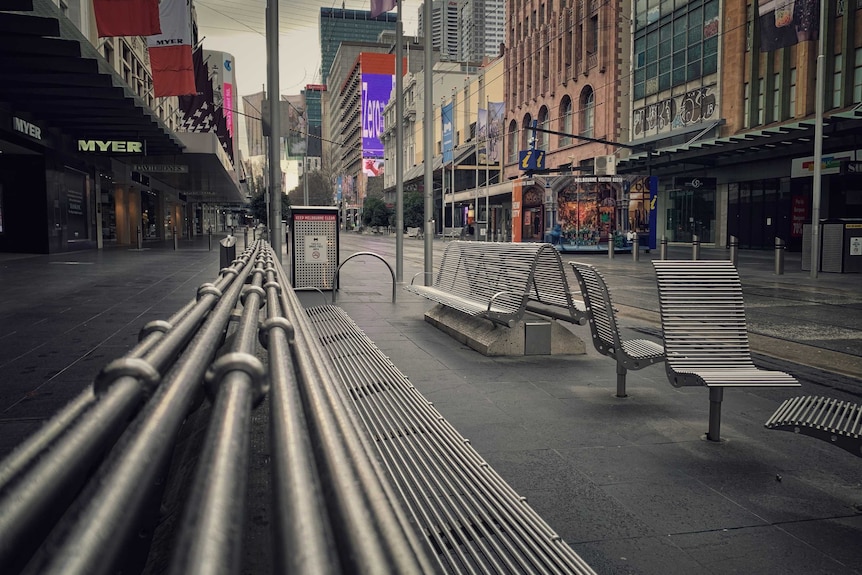 A bench in an empty Bourke Street Mall.