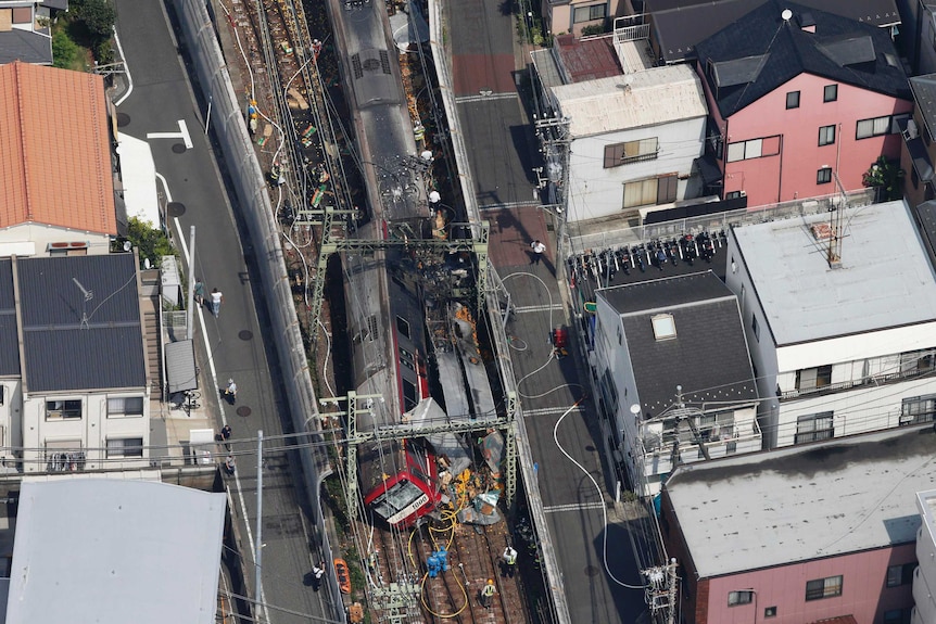 A birds eye view of a derailed train after a collision with a truck.