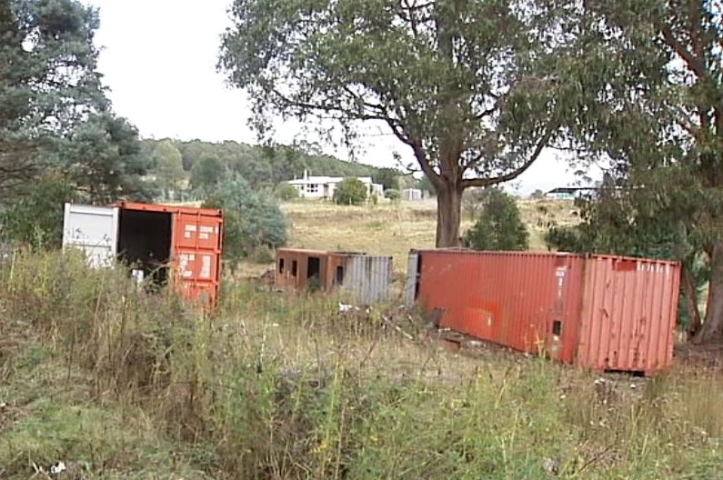 Shipping containers at the Mount Lloyd property where a woman died.