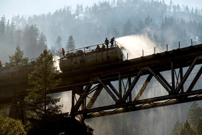 Firefighters spray water from Union Pacific Railroad's fire train.