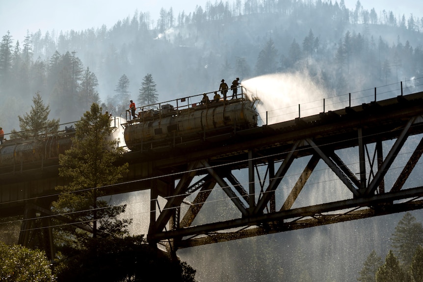 Firefighters spray water from Union Pacific Railroad's fire train.