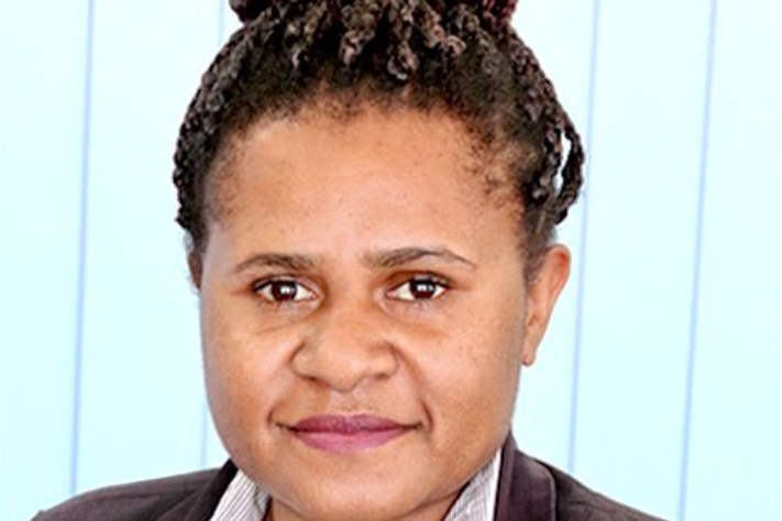 A PNG woman with braids tied up in professional suit attire
