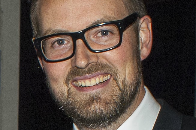 A man wearing glasses with a beard