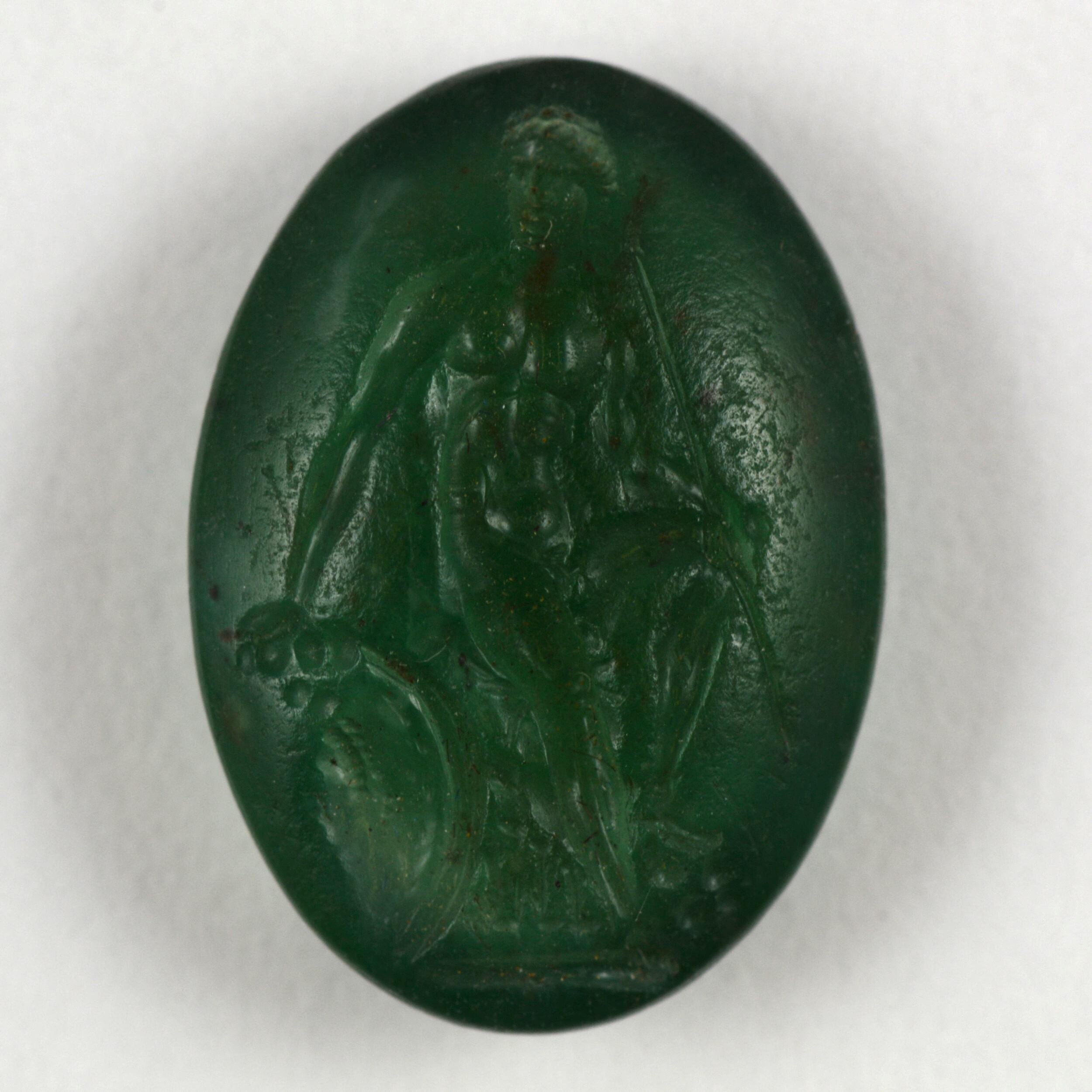 A green plasma intaglio against a white background