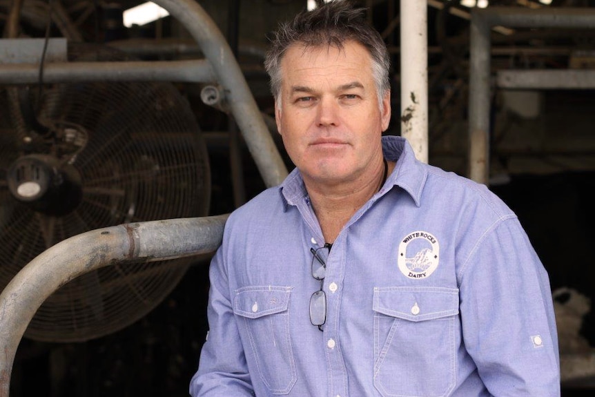 A mid shot of Michael partridge from the waist up, outdoors in front of a farm shed.