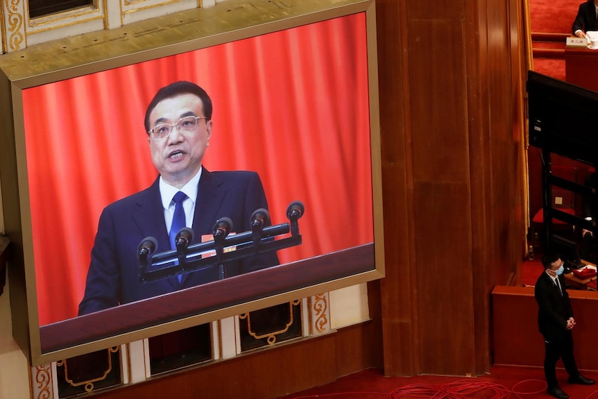 Chinese Premier Li Keqiang is seen on a screen as he delivers a speech at the opening session of the National People's Congress.