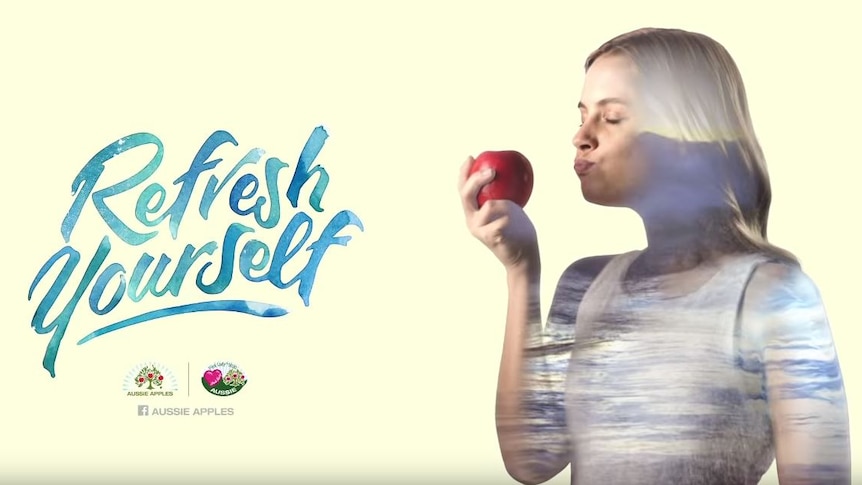 An ad campaign showing a woman biting into an apple.