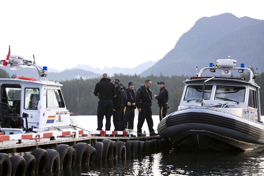Royal Canadian Mounted Police (RCMP) officers search for the last remaining body following the capsize of the Leviathan II vessel