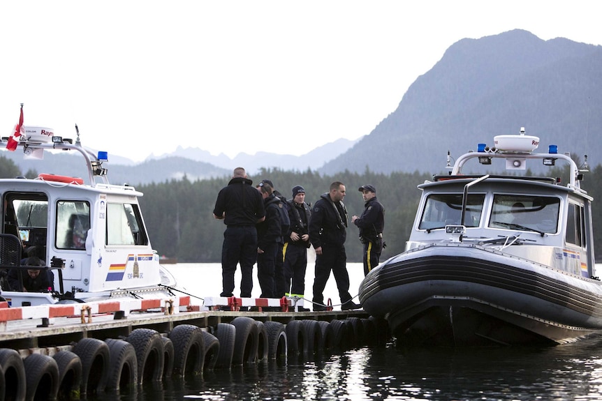 Royal Canadian Mounted Police (RCMP) officers search for the last remaining body following the capsize of the Leviathan II vessel