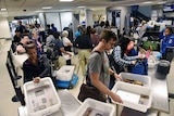 Passengers at a TSA security check at LAX