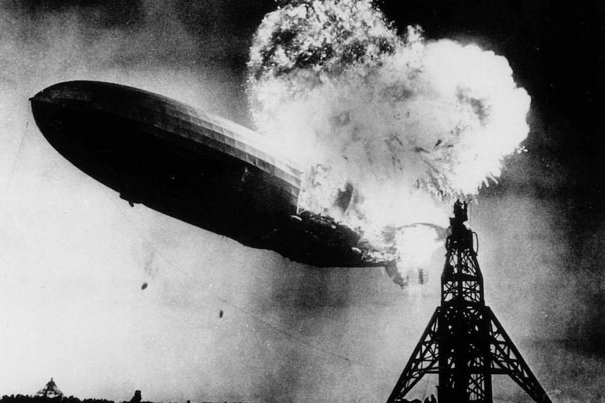 A close up photo of the hindenberg ship burning in the sky.