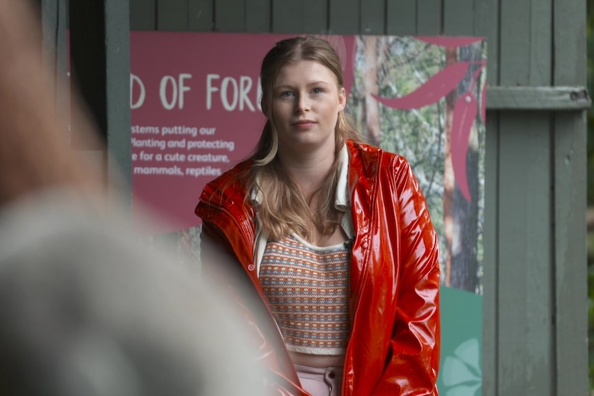 A young woman in a red jacket 