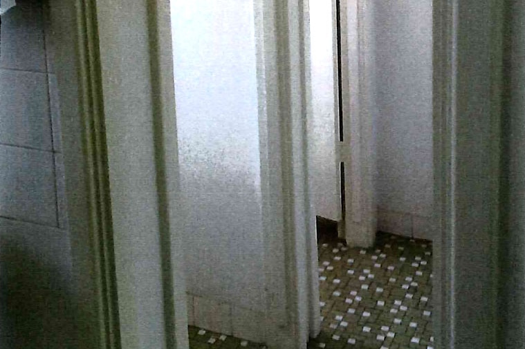 A grainy photograph of an old-fashioned bathroom