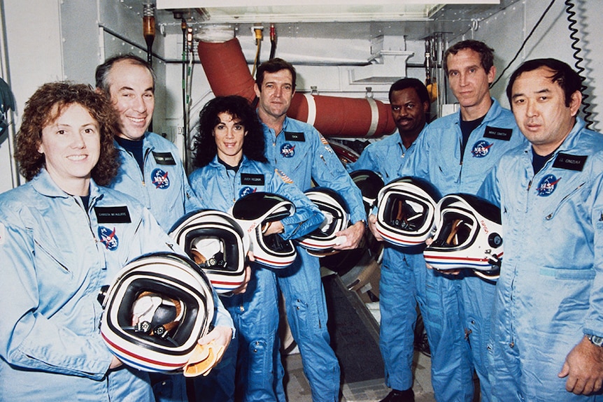 The five men and two women of the Space Shuttle Challenger crew, posing in their flight suits.