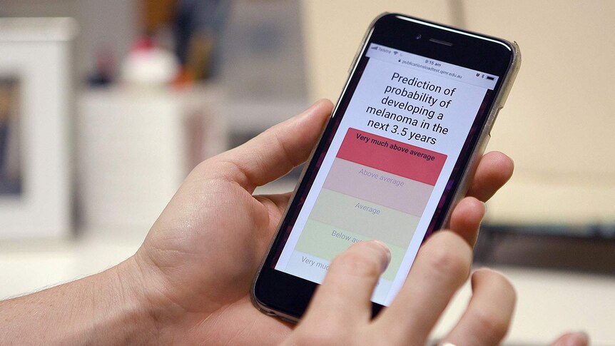 A hand holding a phone with the online test showing on the screen