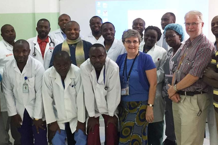 Dr Neil Wetzig and his wife Gwen Wetzig stands with a large group of hospital staff in Goma