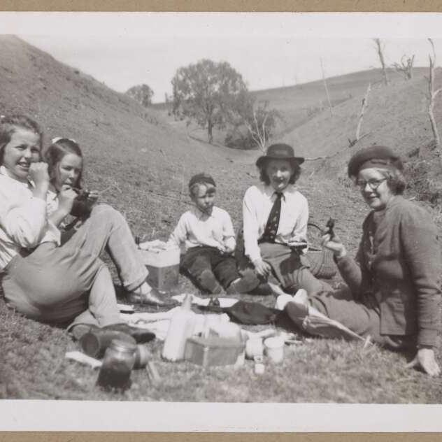 Family group seated on picnic rug at Millamolong Station, Mandurama Region, NSW. Historic photo taken 1946.