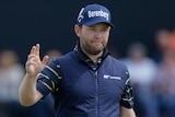 South Africa's Branden Grace holds his hand up as he celebrates a British Open birdie.