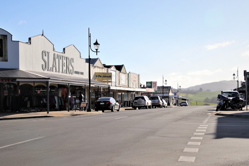 A quiet country town street with no traffic on the road.