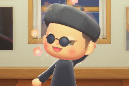 A 3D virtual character in black sunglasses, beret and shirt, stands and waves in virtual art gallery near window.