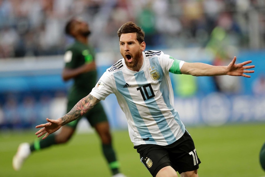 Lionel Messi celebrates scoring against Nigeria