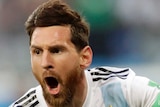 Lionel Messi celebrates scoring against Nigeria