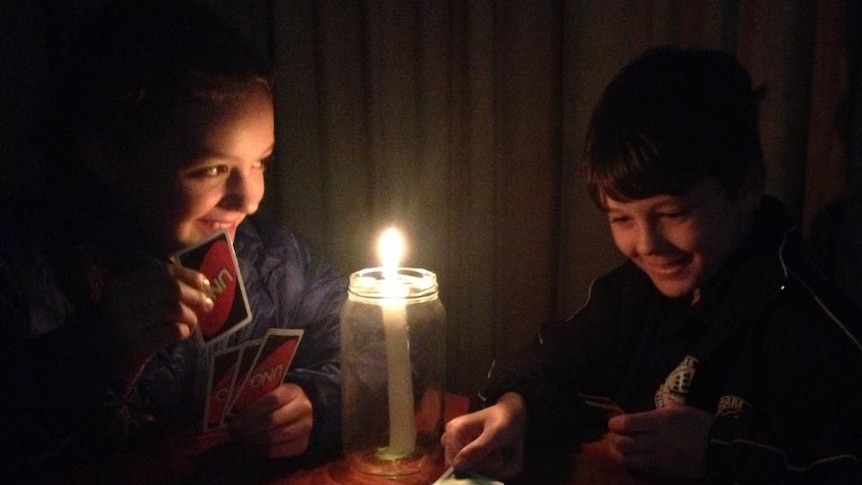 Kids play Uno in the dark during blackout