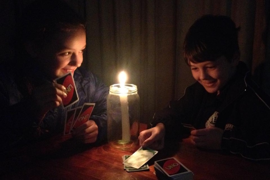 Kids play Uno in the dark during blackout