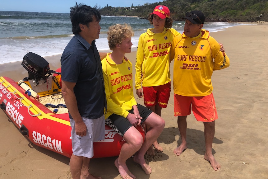 Andrew Bau talking to his rescuers and team leader on the beach 