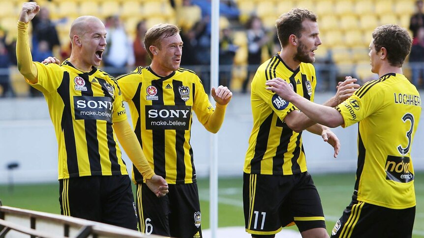 Wellington Phoenix players celebrate Stein Huysegems' (L) goal against Brisbane Roar.
