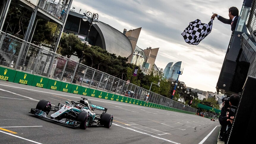 Mercedes driver Lewis Hamilton crosses the finish line to win the 2018 Azerbaijan F1 Grand Prix.