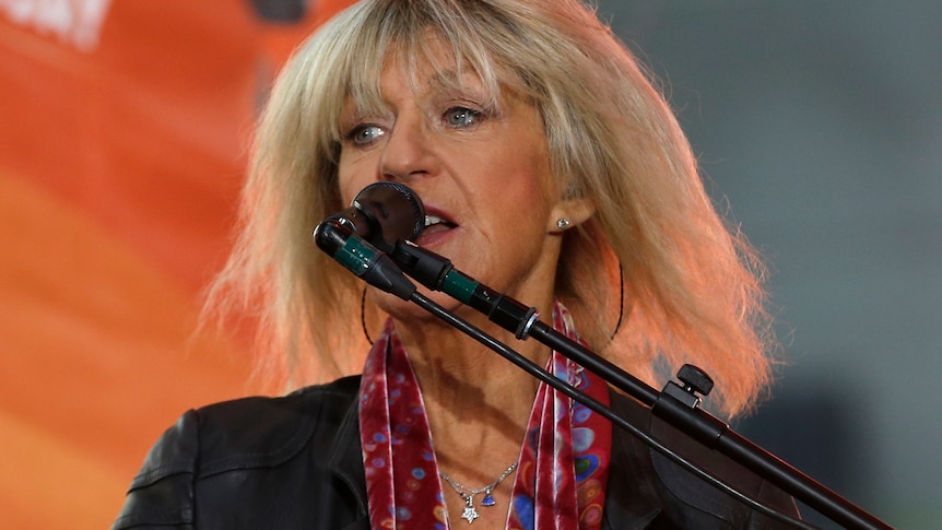 Christine McVie is seen before a microphone