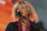 Christine McVie is seen before a microphone