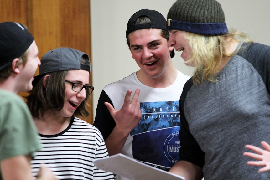 Four young men singing