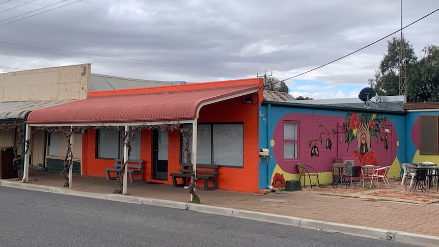 An orange frontage of a cafe that is closed.  