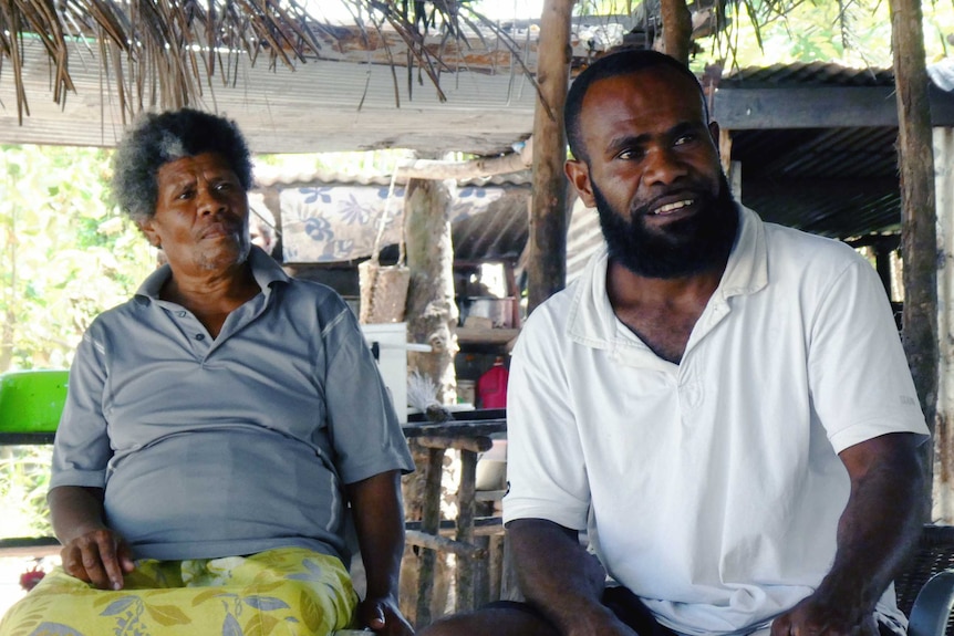 Gabriel Toara, left, and her son Graham Toara, right, whose village neighbours Rainbow City.