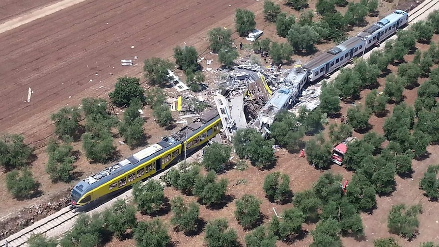 Two smashed carriages thrown across the tracks after a head-on collision between two trains.