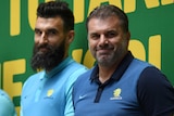 Mile Jedinak and Ange Postecoglou smile on stage at Martin Place during a public reception for the Socceroos.