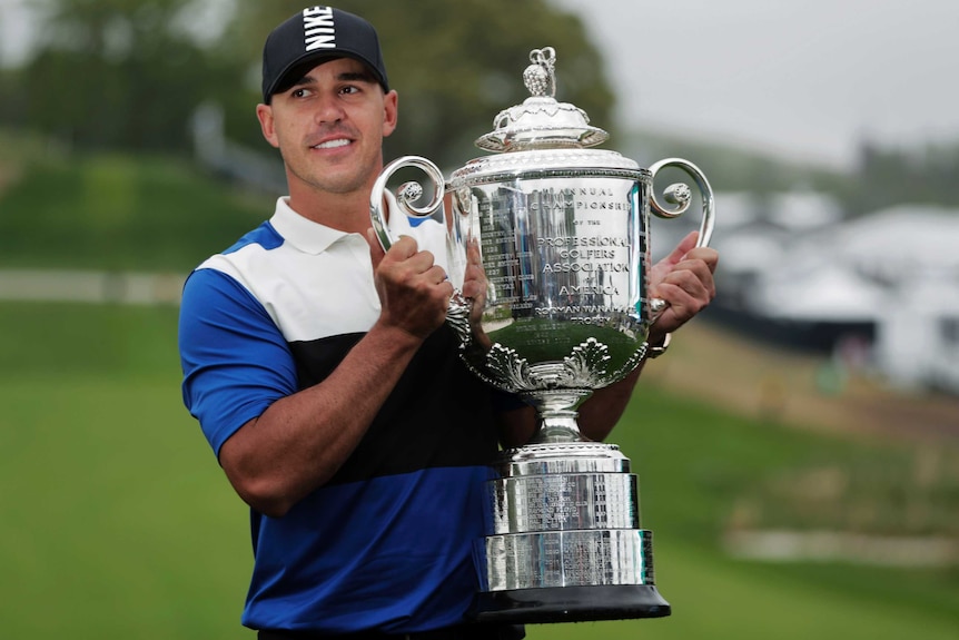 Brooks Koepka holds the US PGA Championship trophy