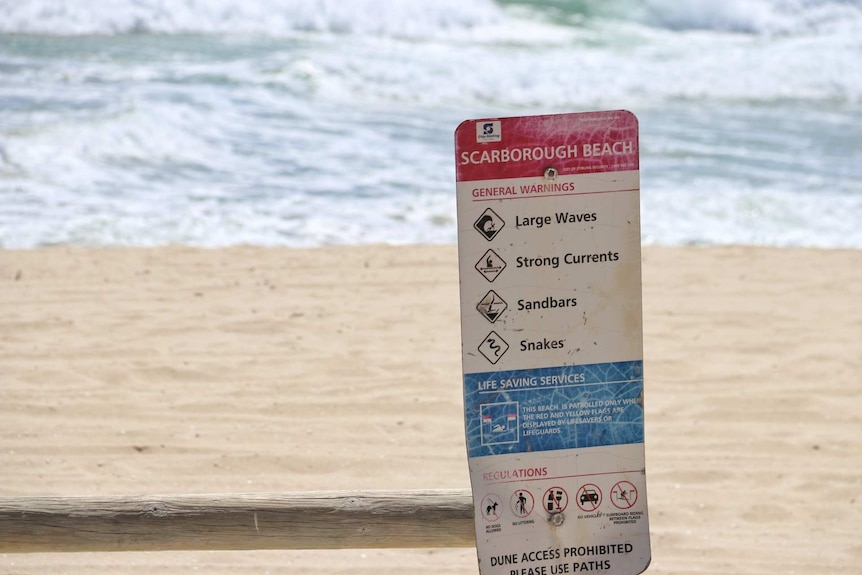 A warning sign on a beach.