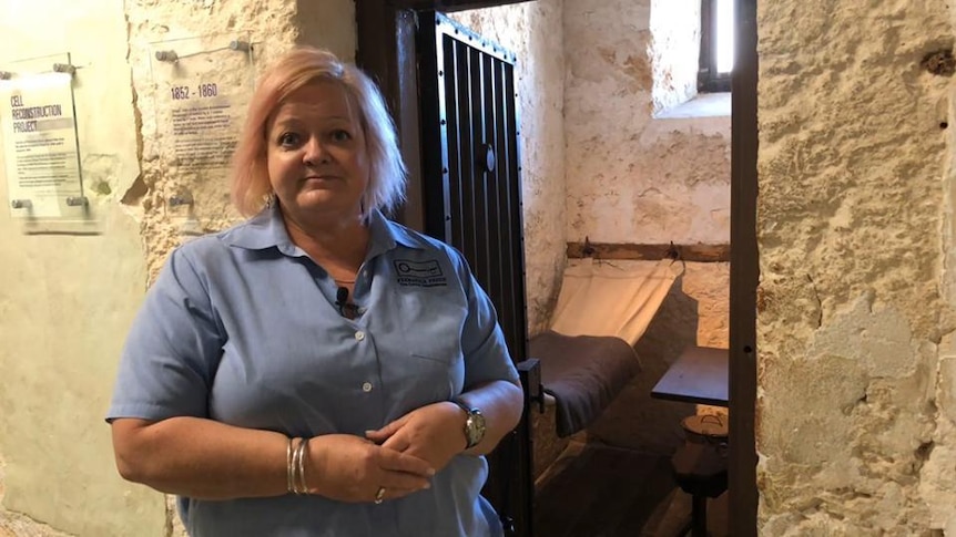 Woman stands at door of Fremantle Prison cell