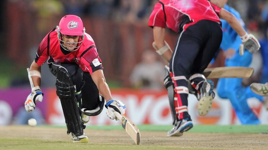 Mitchell Starc from the Sydney Sixers dives for the winning run in the Champions League semi-final.