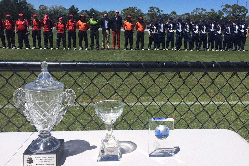 Trophies in front of the British Army and Australian Navy teams.