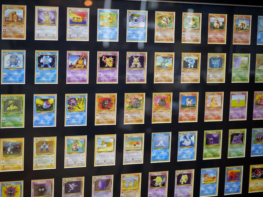 Rows and rows of brightly coloured Pokemon cards on display with a black backing