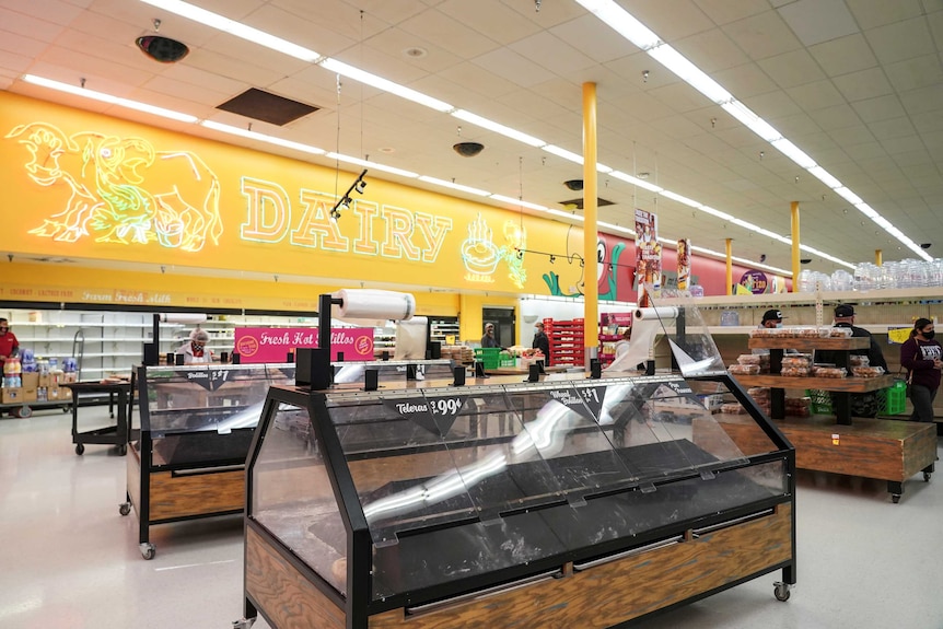 Empty shelves are seen at bakery section of a Texas supermarket