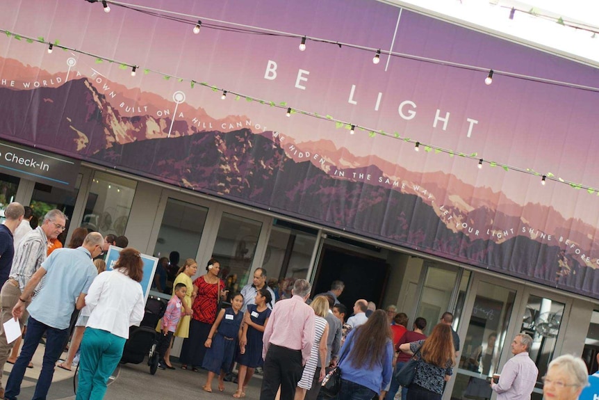 People outside a modern building